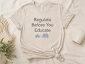 Heather sand adult tee printed with Regulate Before You Educate and a turtle and elephant